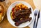 Beef steak on the bone with stew vegetables served at plate, spanish cuisine