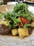 Beef steak with gravy sauce, potatoe gnocchi, fresh tomatoes and rocket leaves