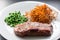 Beef steak with green peas and sweet potato