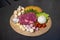 Beef steak and mushroom sauce menu raw ingredient in circle wicker plate on black granite kitchen counter surface