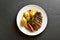 Beef steak with potato and caramelized onion