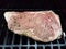 Beef steak with seasoning cooking on barbecue grill