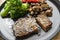 Beef steak with vegetables like broccoli, champignons and tomato