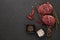 Beef steaks on cutting board and spices on black slate background. Top view. Steak menu