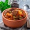 Beef stew with potato, green beans, carrot, peas and corn, in ceramic bowl, square format