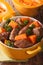 Beef stew with pumpkin macro in a pot. vertical