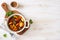 Beef stewed with vegetables on a white wooden background