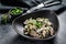 Beef stroganoff with mushrooms in a plate with cremini and champignons. Black background. Top view