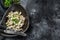 Beef stroganoff with mushrooms in a plate with cremini and champignons. Black background. Top view. Copy space