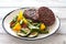 Beefsteaks grilled with vegetables in white plate