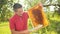 Beekeeper cuts wax from honeycomb frame with a special electric knife