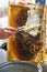 Beekeeper cuts wax off