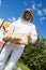 Beekeeper Holding Honeycomb Frame At Apiary