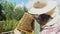 Beekeeper holding a honeycomb full of bees closeup