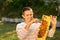 Beekeeper holding a honeycomb full of bees. A man smiling and gently resting his hand with the bees on his face