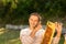 Beekeeper holding a honeycomb full of bees. A man smiling and gently resting his hand with the bees on his face