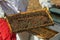 Beekeeper holds a honeycomb with bees in his hands