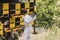 Beekeeper observing and checking a hive entrance