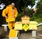 A beekeeper splitting his inventive double hive with an automatic honey dispenser