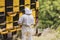 Beekeeper surrounded by a bee swarm, checking the hive