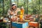 The beekeeper uses a bee brush. The process of harvest honey in the apiary.