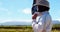 Beekeeper wearing beesuit while preparing for harvest