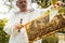 Beekeeper working on bee colony holding honeycomb