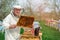 The beekeeper works on a beehive near the hives. Spring work on the apiary.