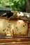 A beekeeper works with a hive of honey bees