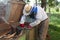 The beekeeper works near the hives. Going to take honey. Retired beekeeper