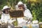 Beekeepers working collect honey. Beekeepers are working with bees and beehives on the apiary