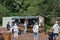 BEELITZ, GERMANY - JUN 30, 2020: Social distancing. People in the park want to buy pizza, grilled sausages or other food for lunch