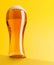 Beer bliss: Refreshing brew against a vibrant yellow backdrop
