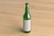 Beer bottle 500ml mock up with blank label on wooden background