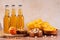 Beer in bottle and snack on wooden table with basketball ball, game night food