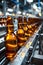 Beer bottles on a conveyor belt in a brewery with soft focus lights.