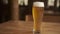 Beer. Cold Craft light Beer in a glass with water drops. Pint of Beer close up on a wooden background. Border design.