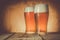 Beer in frosty mugs on rustic background