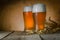 Beer in frosty mugs on rustic background