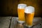 Beer in frosty mugs on rustic background