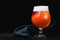 Beer with froth in a glass Snifter isolated on a dark background. isolated glass of beer