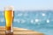 Beer glass on a blurred background of the sea.