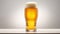 Beer glass filled with lager, with white head and slight glow behind, against neutral background