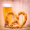 Beer Glass with German Pretzel on wooden