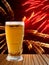 Beer glass on wooden table against of multicolored fireworks.