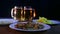 Beer mugs with foam beer on a black background on a wooden table with snacks