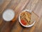 Beer and pilaf with ketchup and bread on the table