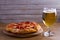 Beer and pizza. Glass of beer. Ale and appetizer snack