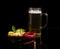 Beer, rusks, basil, chili on a saucer on dark background