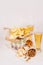 Beer snacks in craft paper and two lager beer in glass on soft fresh wooden table.